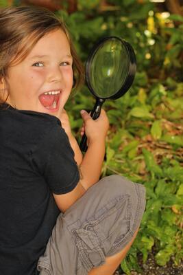 boy playing with a magnifying glass